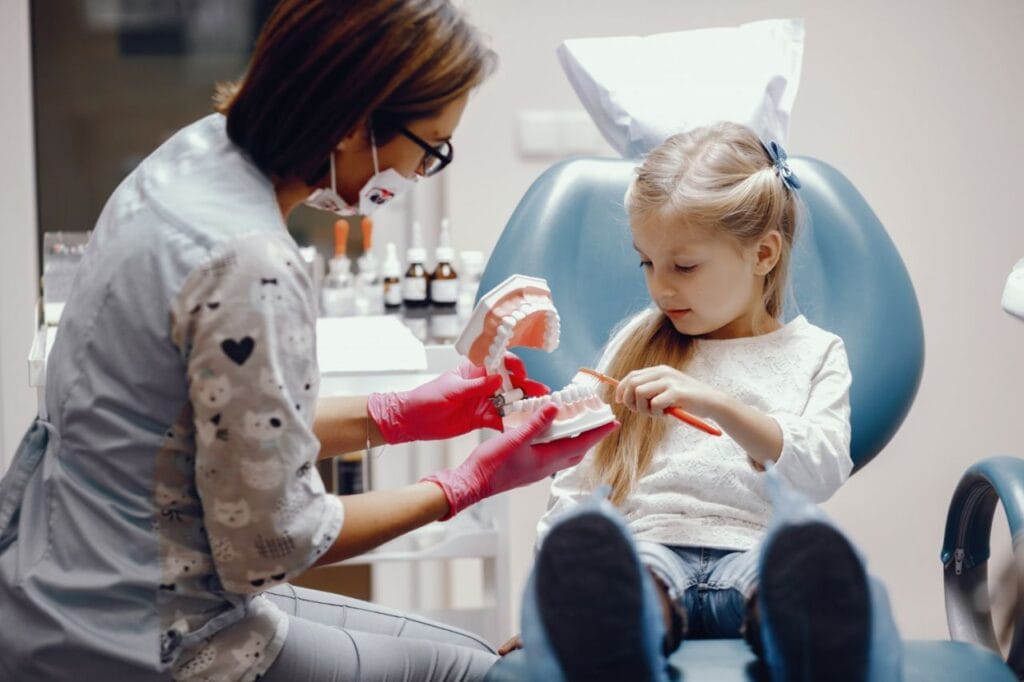 cute little girl sitting dentist s office