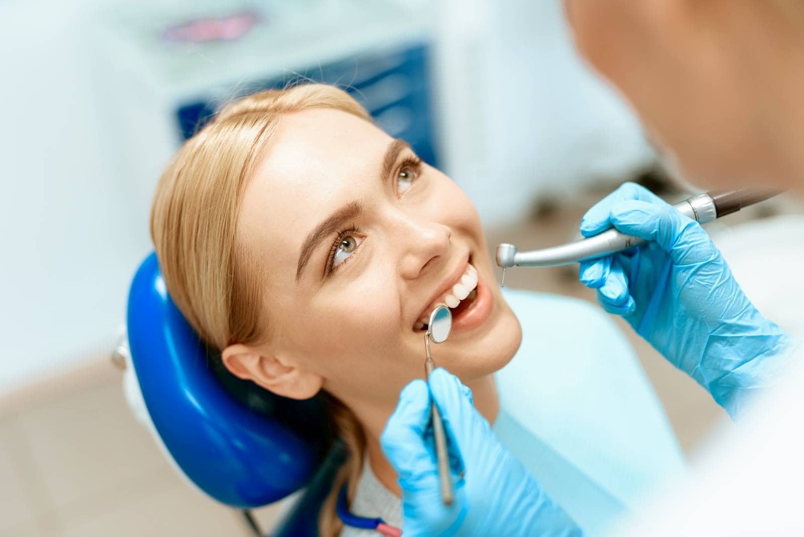 dentist examines a girl in the chair.