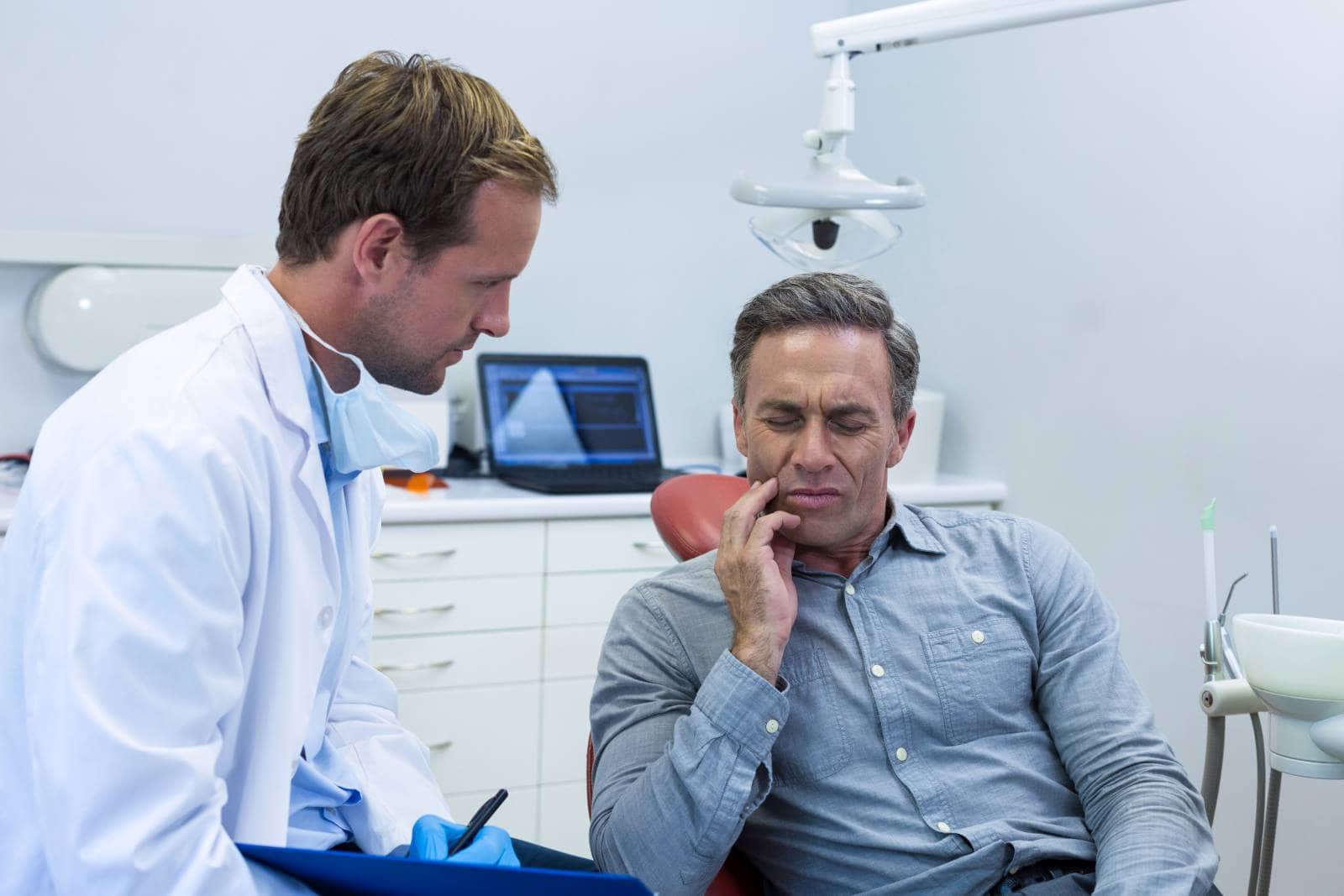 emergency dentist examining a man