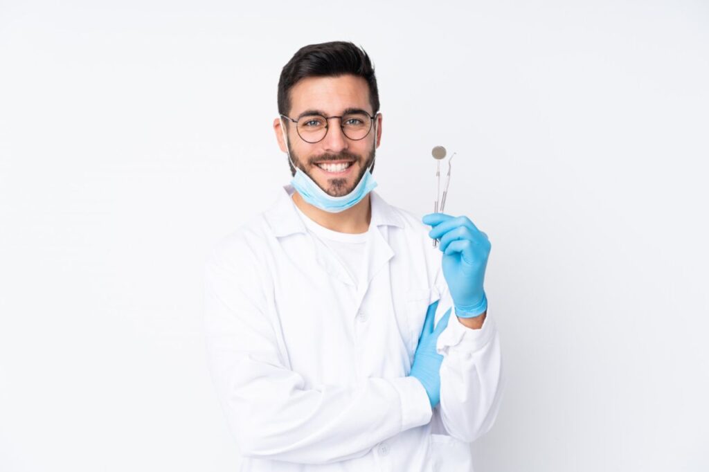 dentist man holding tools isolated white wall laughing