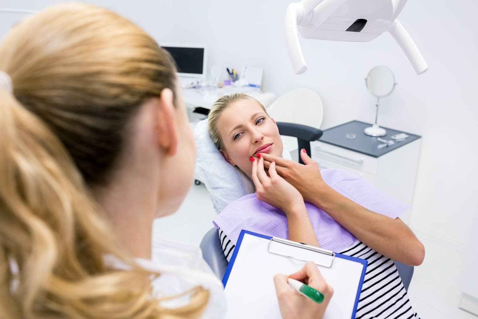 portrait of female patient with toothache in clinic