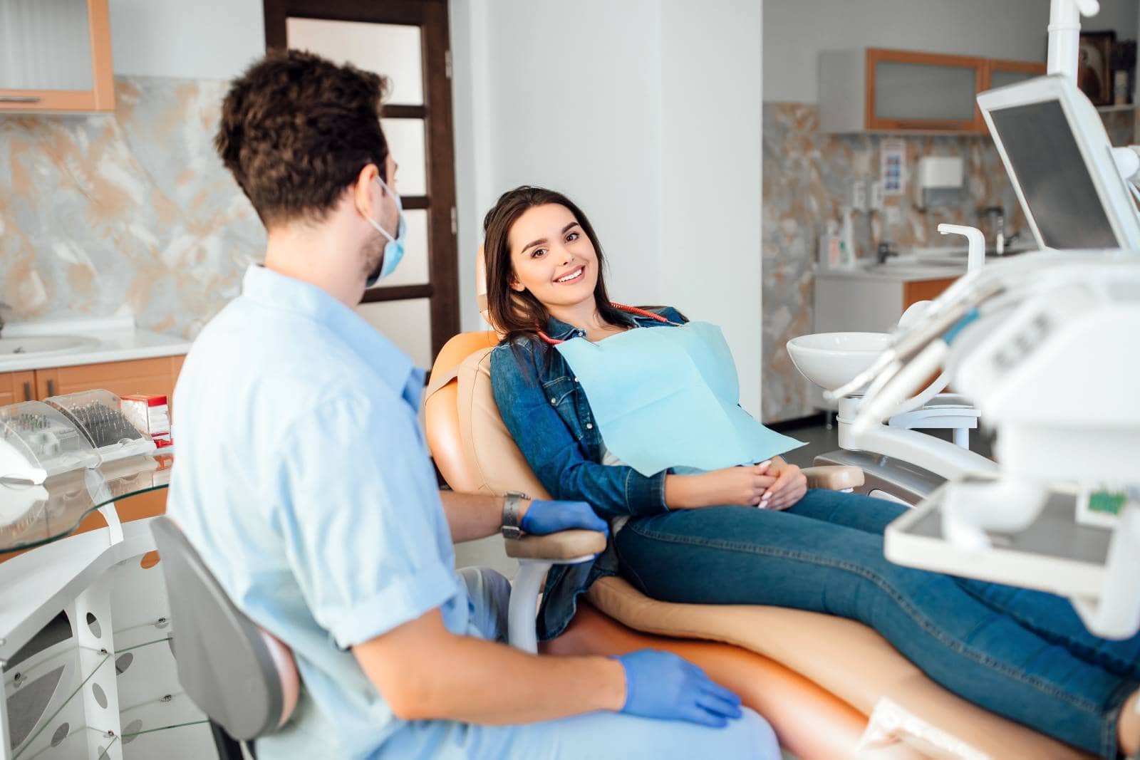 professional dentist man working with patient in modern clinic.